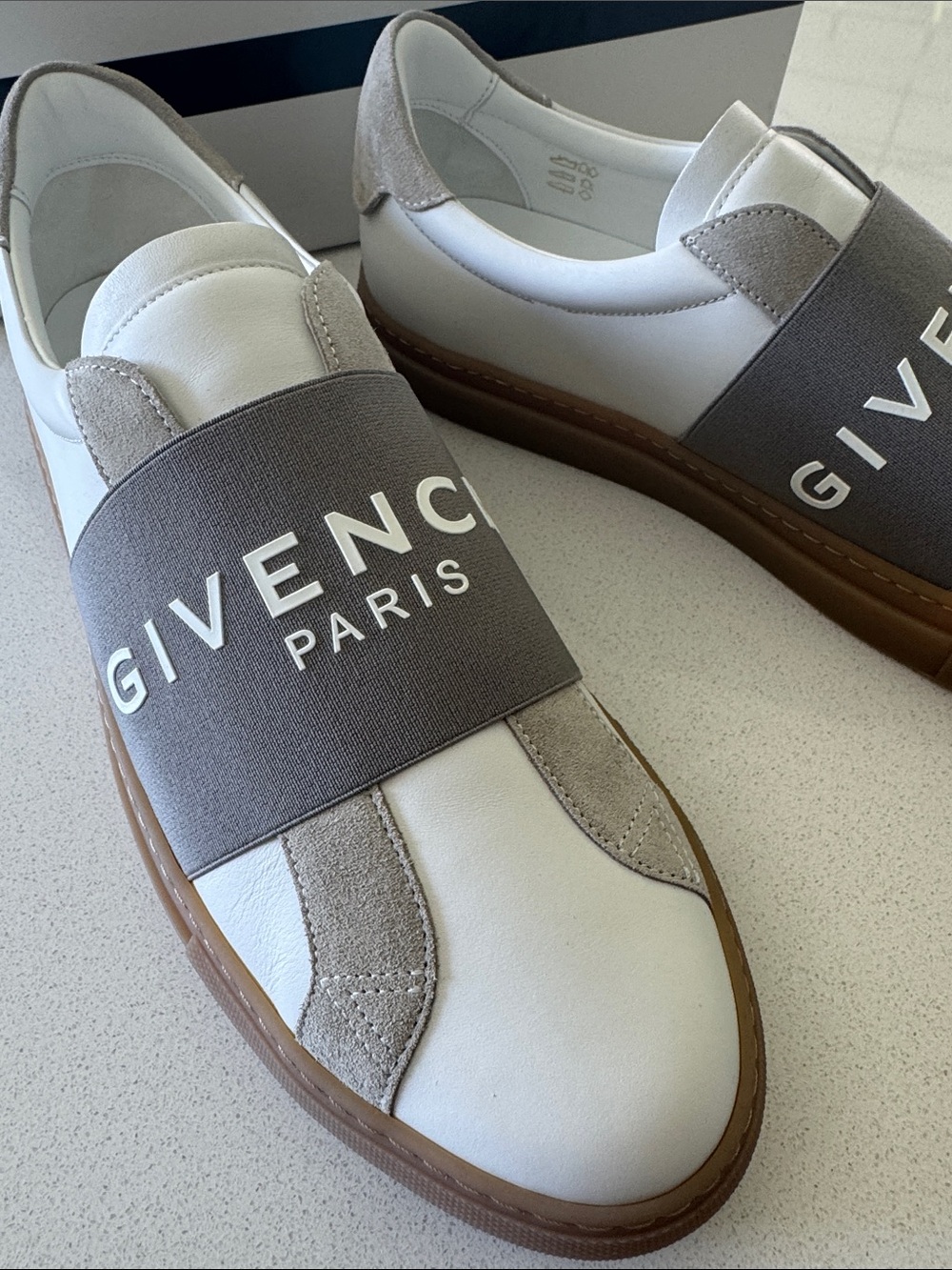 Brand new men’s Givenchy White Leather Slip-On Sneakers w/ Gray& white Logo Band